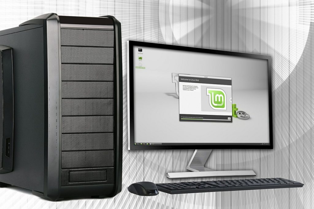 Das Bild zeigt einen Monitor, Computer und Tastatur.